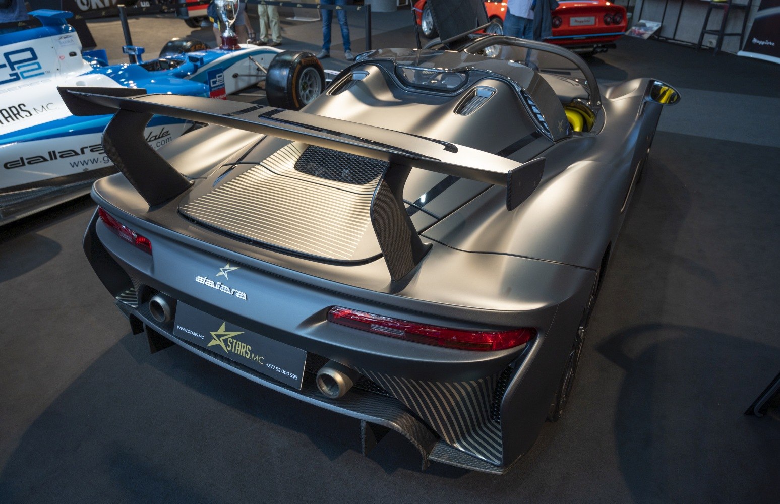 Aerodynamic rear wing and engine cover with dual exhaust pipes
