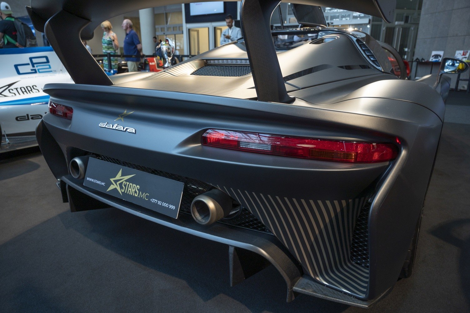 Rear wing and dual exhaust with aerodynamic rear design
