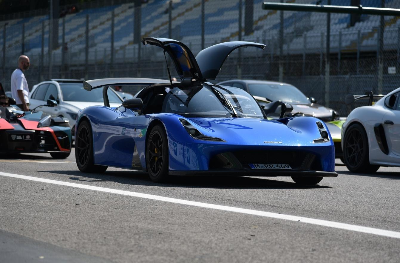Blue sports car with gullwing doors and large rear wing