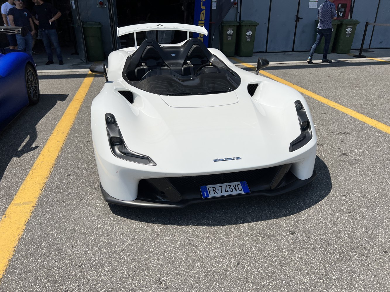 White sports vehicle with open cockpit and aerodynamic front headlights