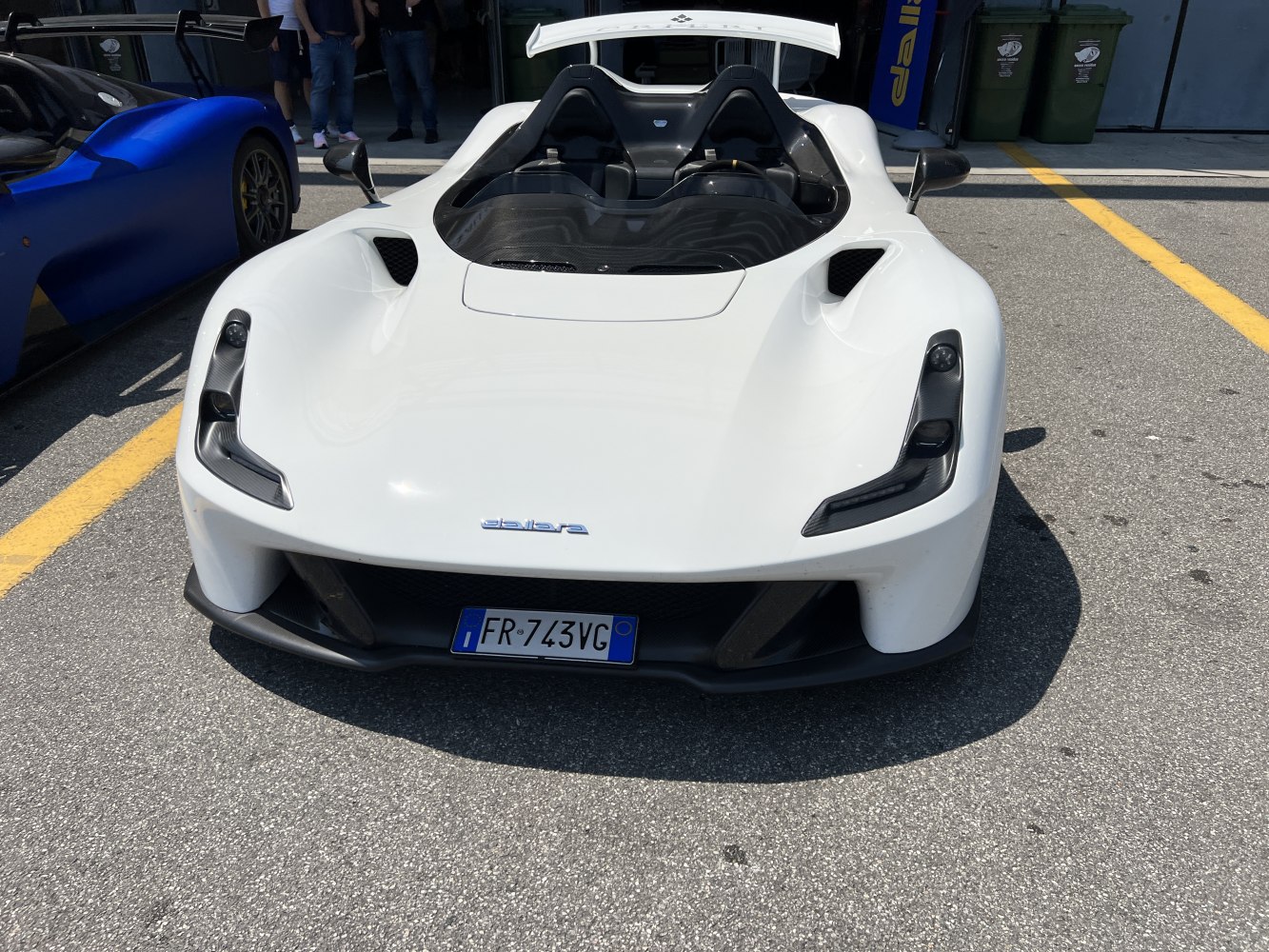 Open-top sports car front with sharp headlights and aerodynamic design