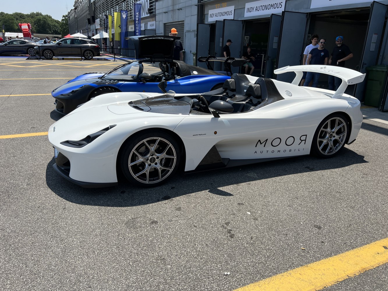 Sleek roadster with aerodynamic wing and open cockpit seating