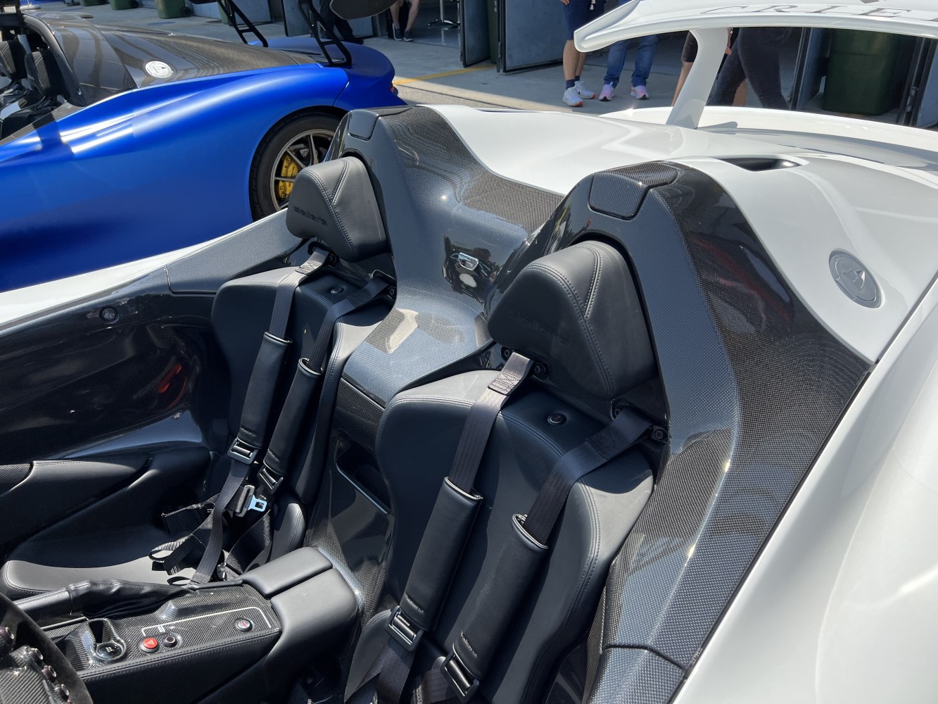 Carbon fiber interior with racing bucket seats and harnesses
