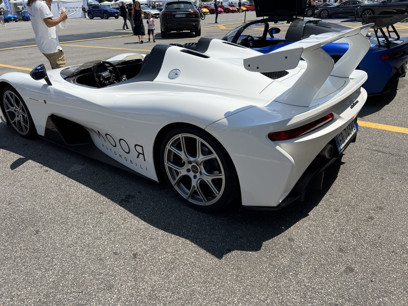 Open-top racing sports car rear view with large aerodynamic wing