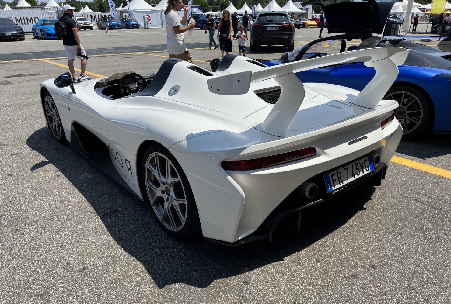 Open cockpit sports car with aerodynamic rear wing and wide wheels