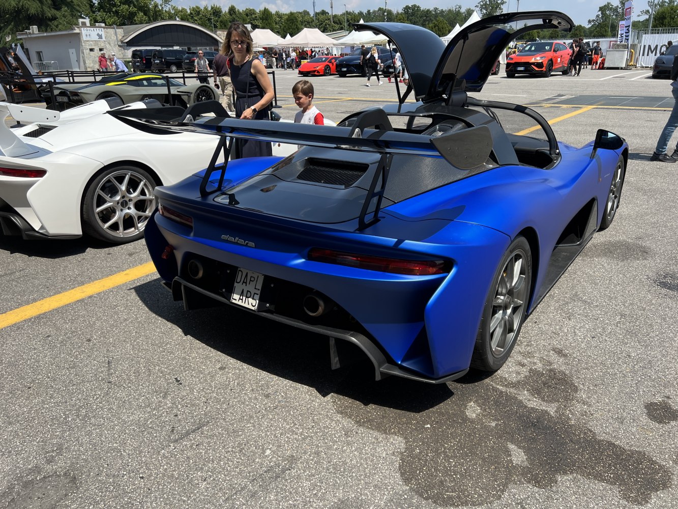 Rear with large wing, dual exhausts and open upward door