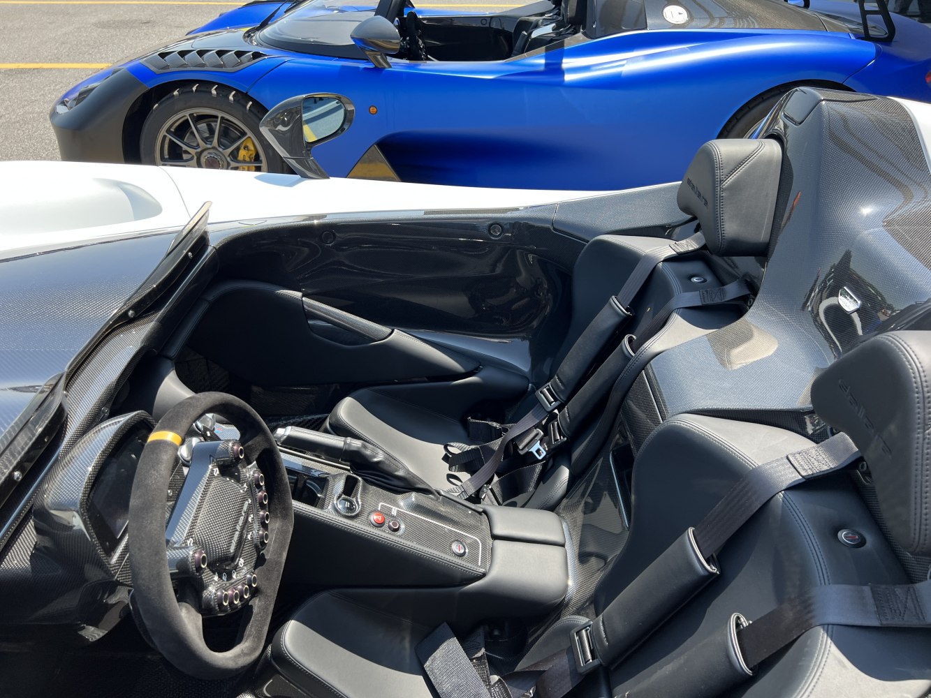 Carbon fiber racing interior with bucket seats and sleek side profile