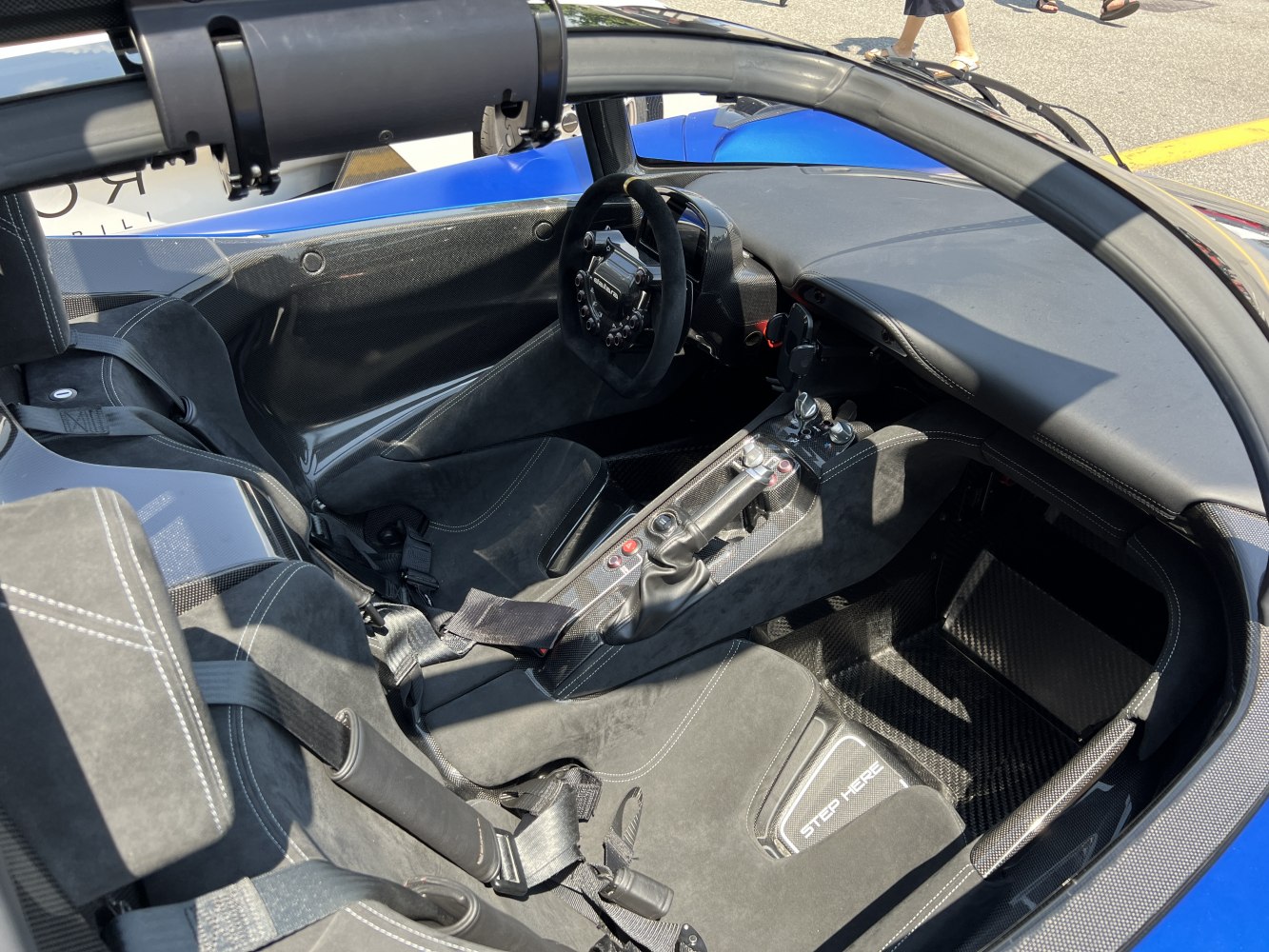 Carbon fiber cockpit, racing seats with harness, advanced steering wheel