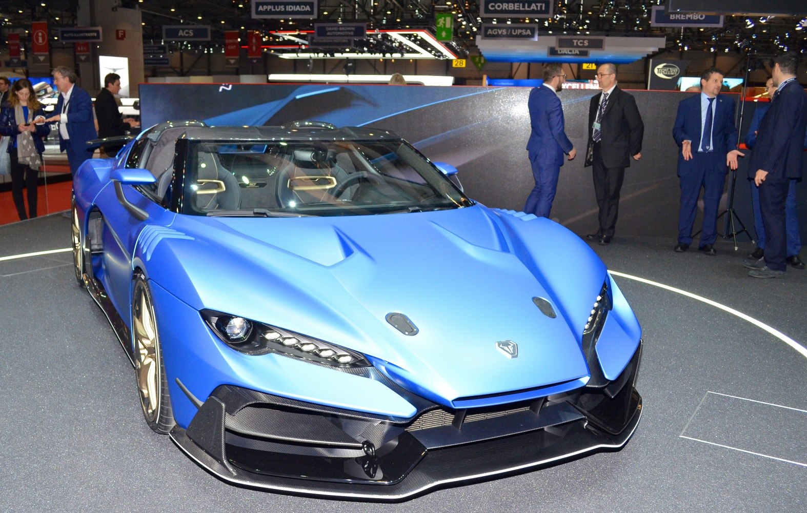 Front view of a sporty matte blue supercar with sharp headlights and aerodynamic features