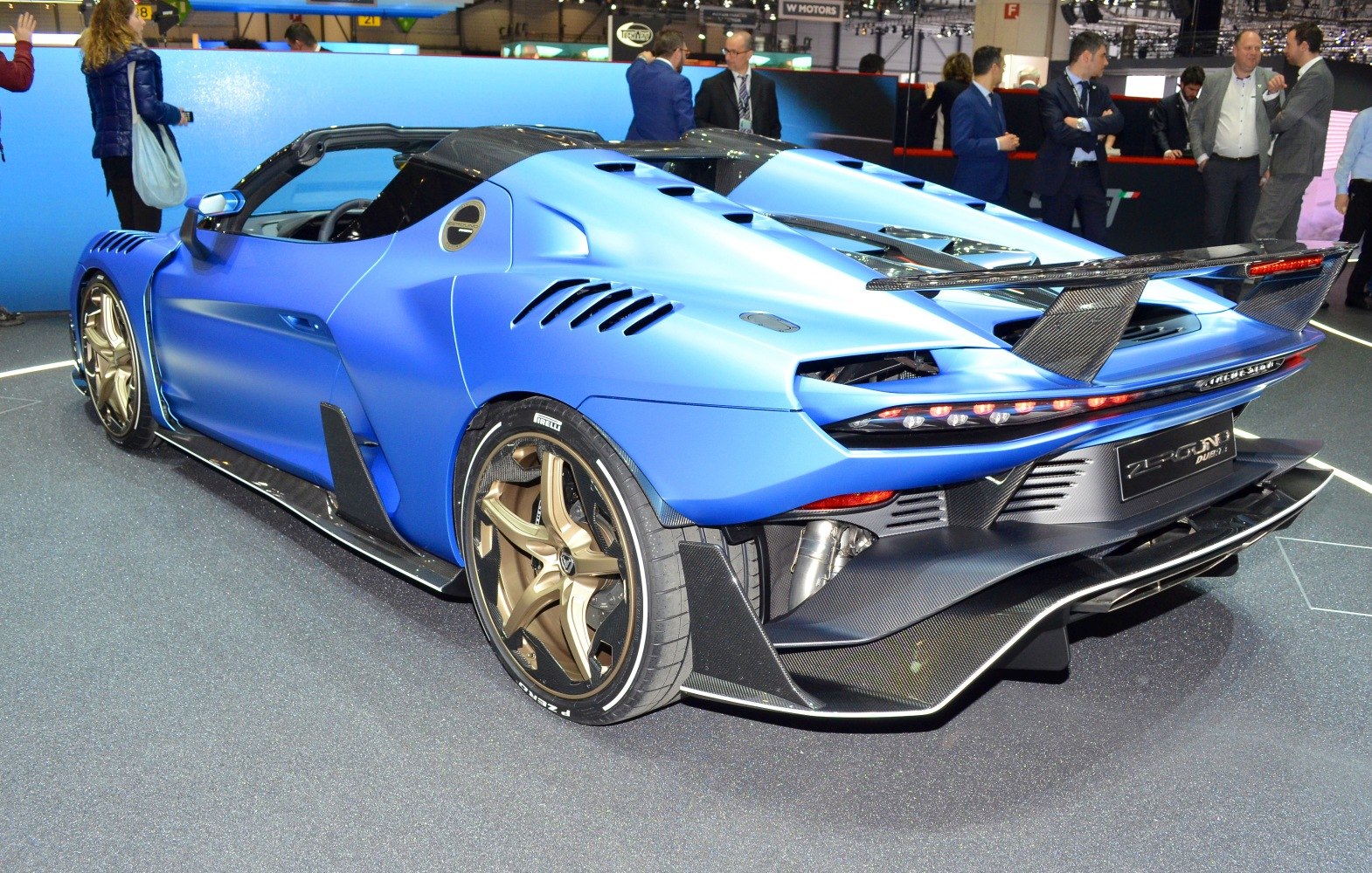 Rear view with carbon fiber wing, aerodynamic vents, and gold rims