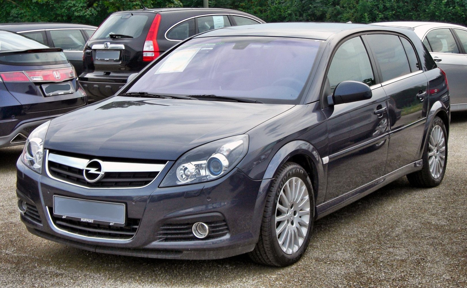 Front view with headlights, grille, fog lights, and alloy wheels