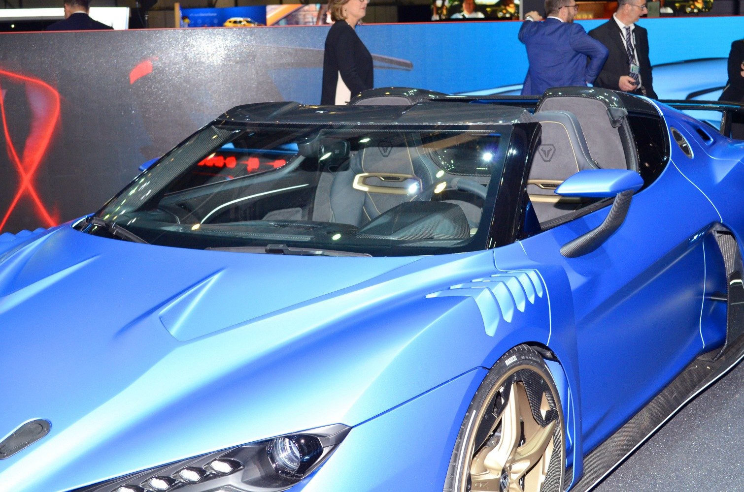 Open-top sports supercar front with aerodynamic vents and detailed headlights