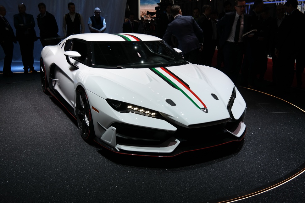 Front view of a sleek supercar with Italian tri-color stripe and aerodynamic design