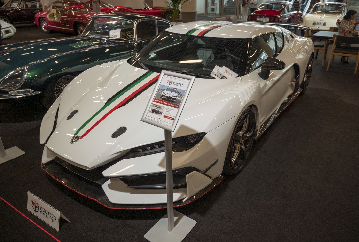 White supercar with Italian racing stripes and aerodynamic front design