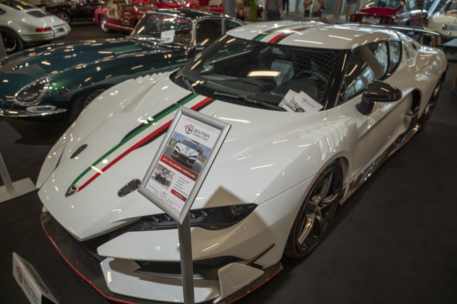 White supercar with Italian flag stripes and aggressive aerodynamic styling