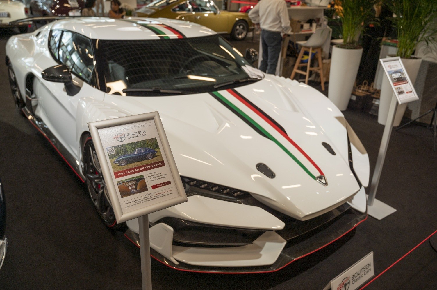 Front view of white sports car with Italian flag stripe and aggressive aerodynamic styling.