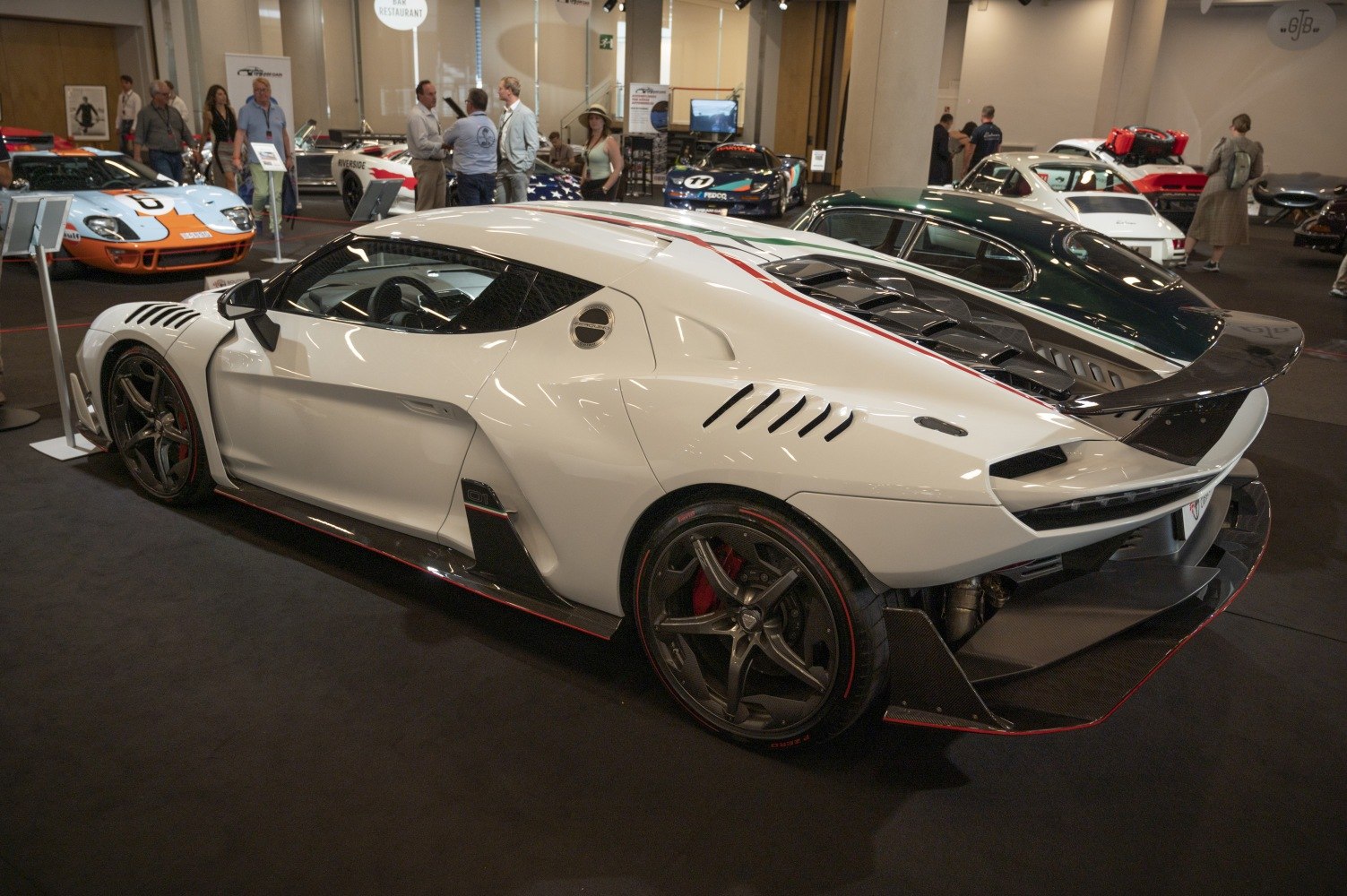 White sports car rear side with aerodynamic vents and black alloy wheels