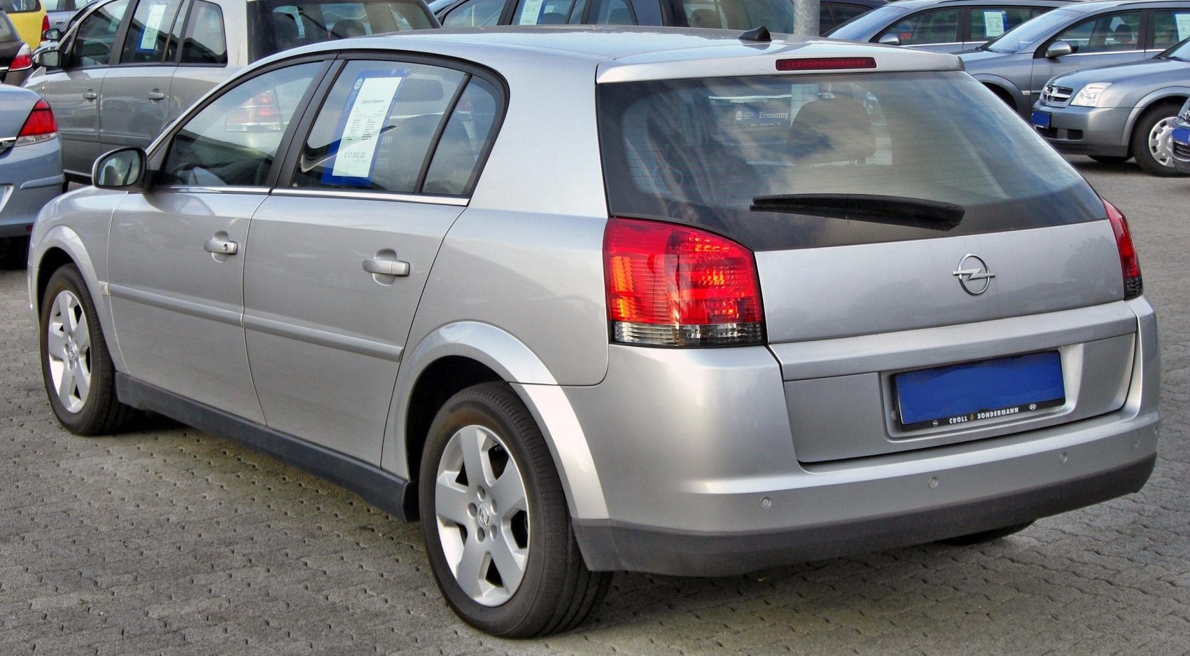 Silver hatchback rear with distinctive taillights and five-spoke alloy wheels
