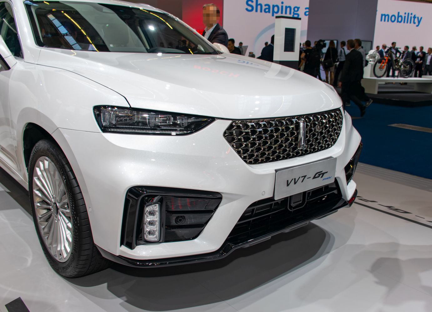 Close-up of front grille and LED headlights with aerodynamic bumper