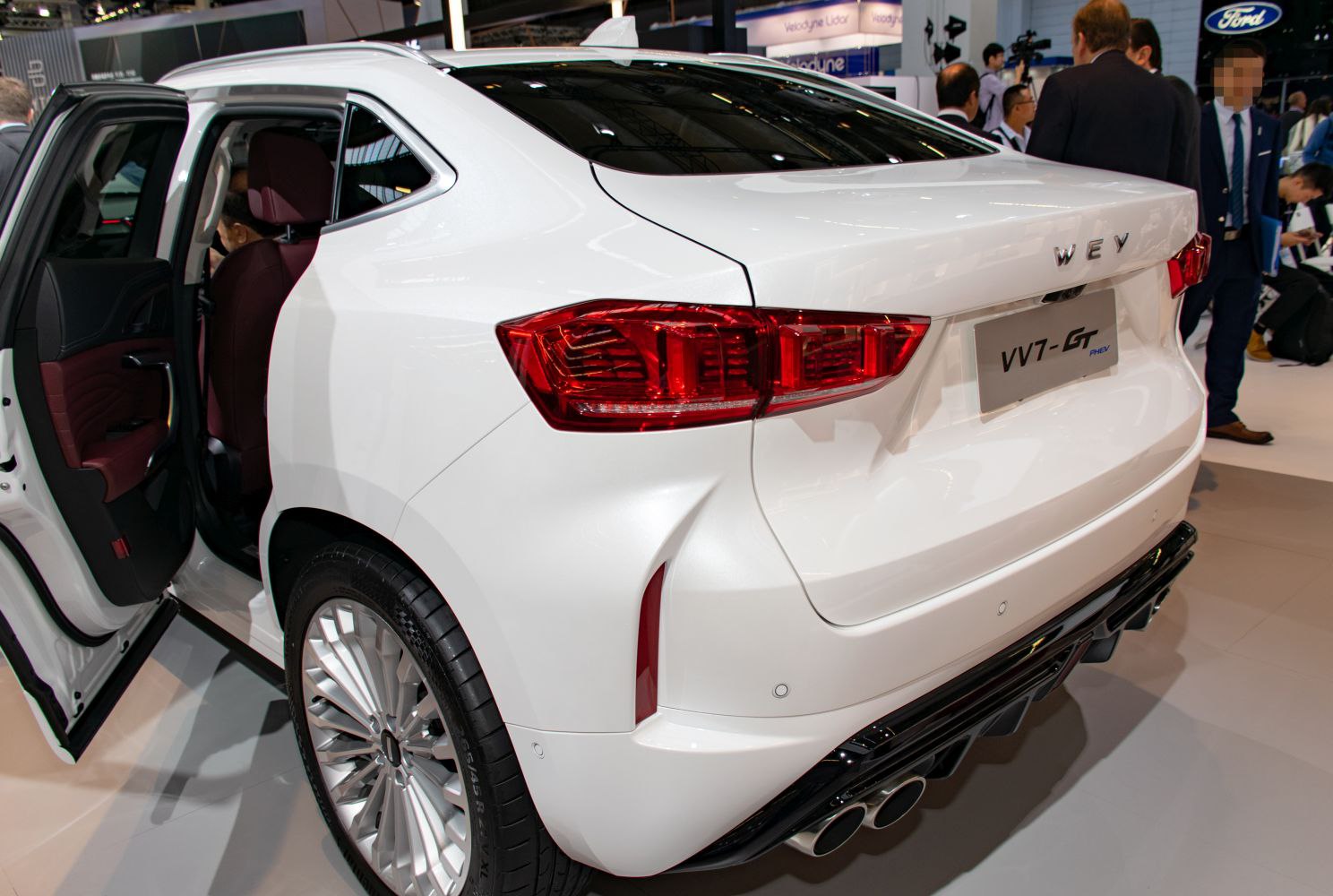 Rear-side of vehicle with open rear door and dual exhaust