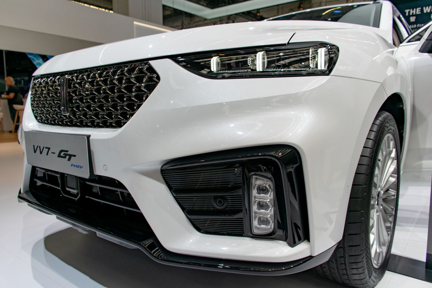 Close-up of front grille, LED headlights, and front wheel.