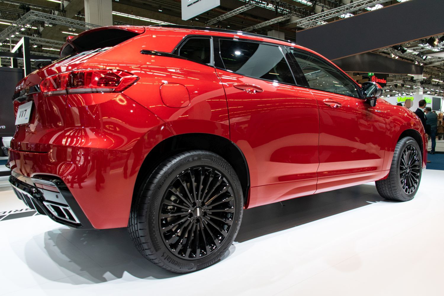 Red SUV rear side profile with black multi-spoke alloy wheels