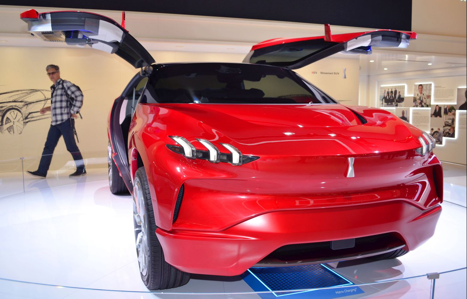 Futuristic SUV with gullwing doors and triple LED headlights