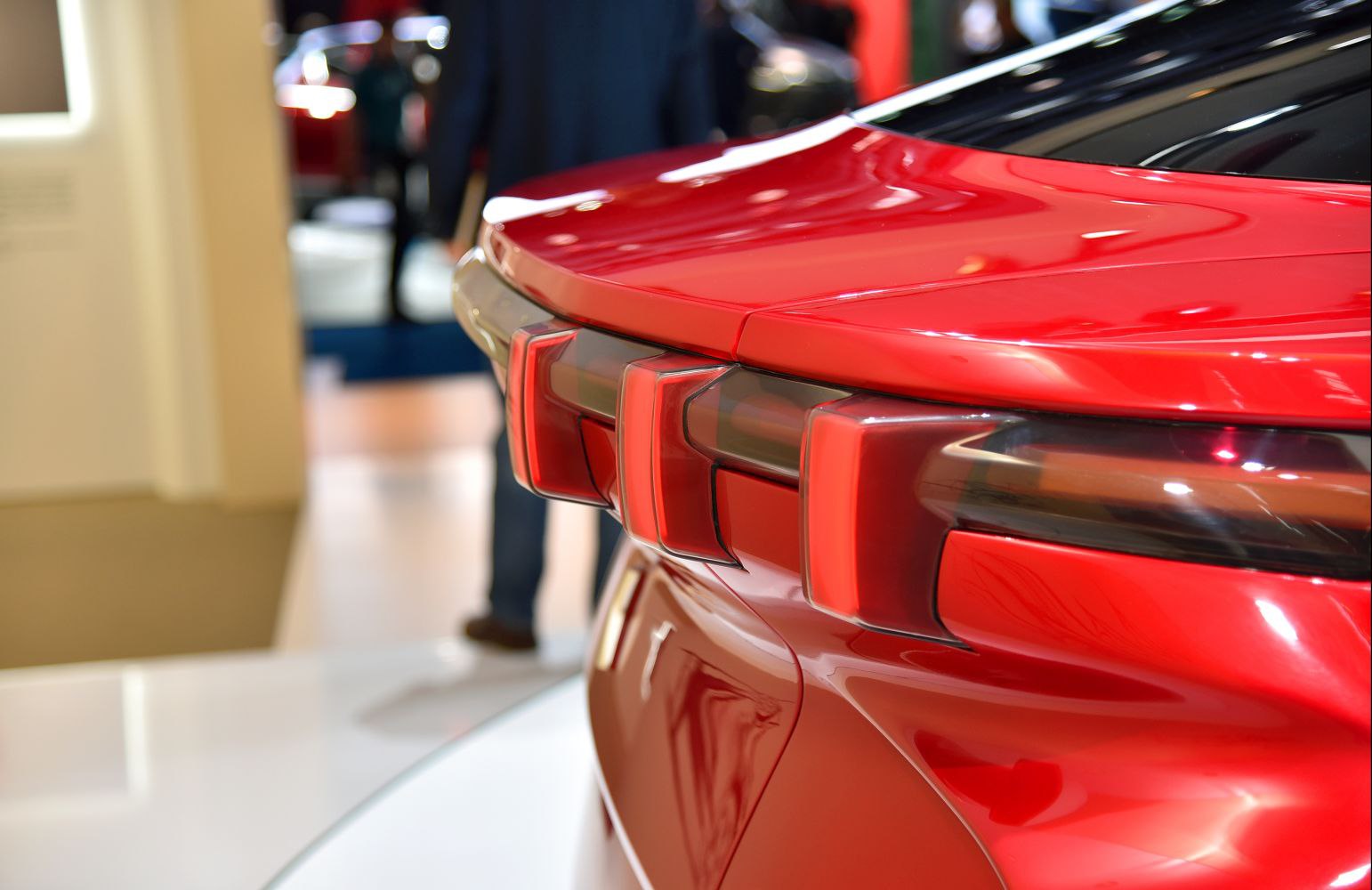 Distinct vertical LED taillights and glossy red rear surface with smooth curves