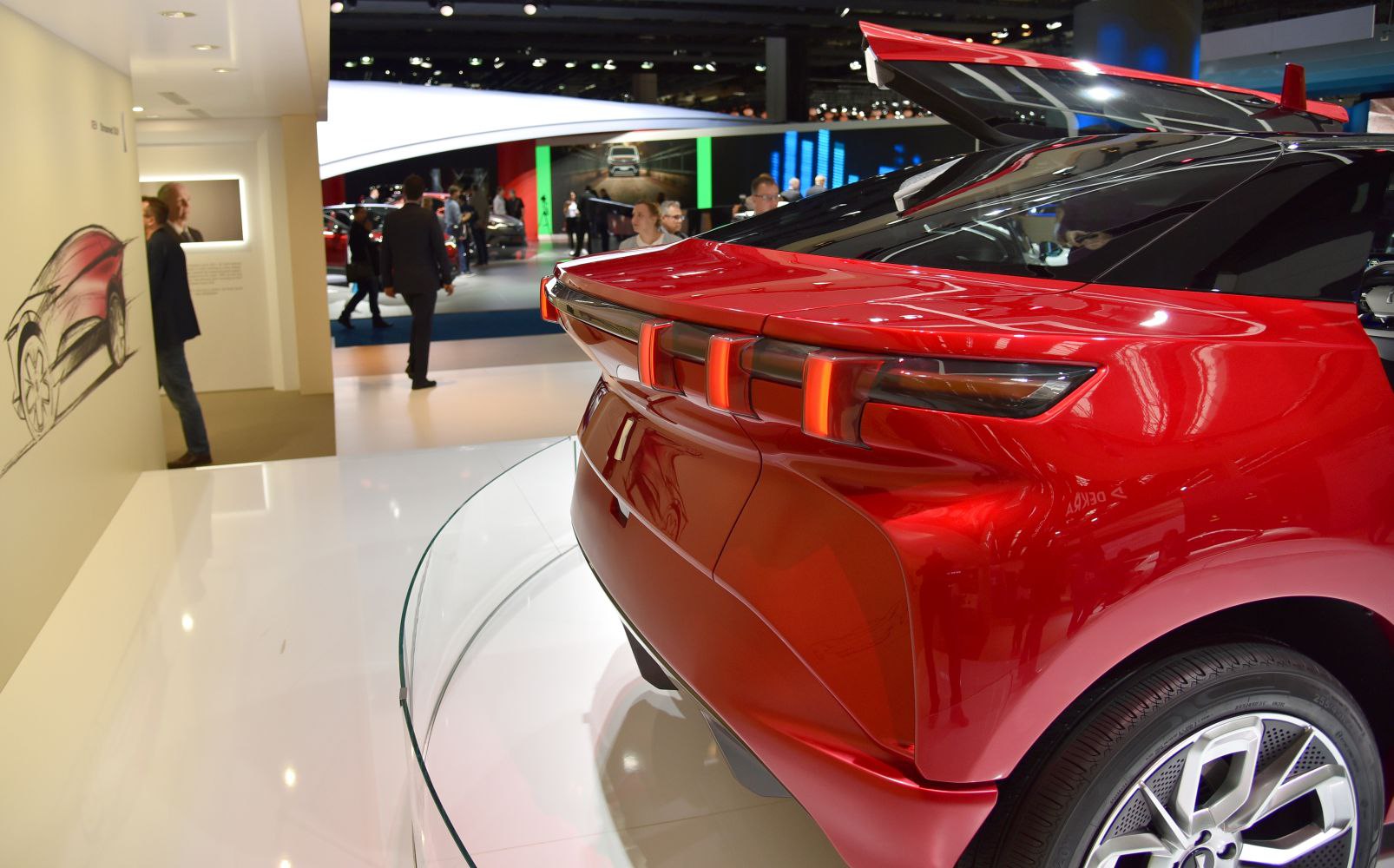 Triple vertical LED tail lights and sleek rear design of a concept SUV.