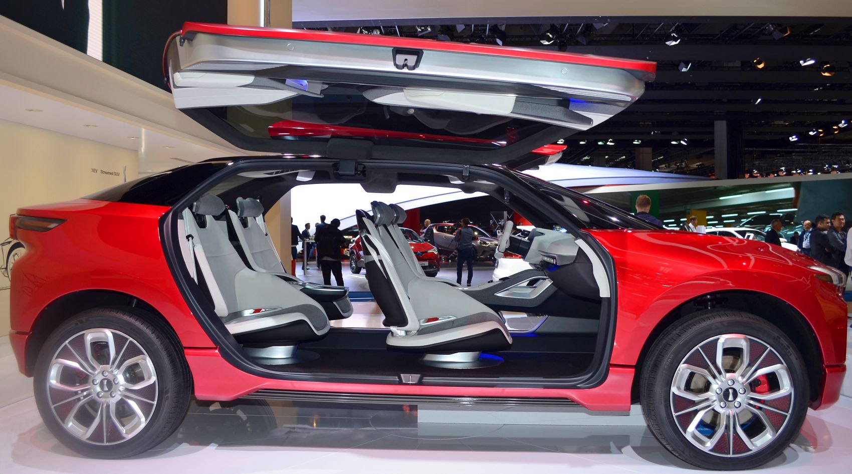 Gullwing doors and futuristic interior seating inside a red concept SUV