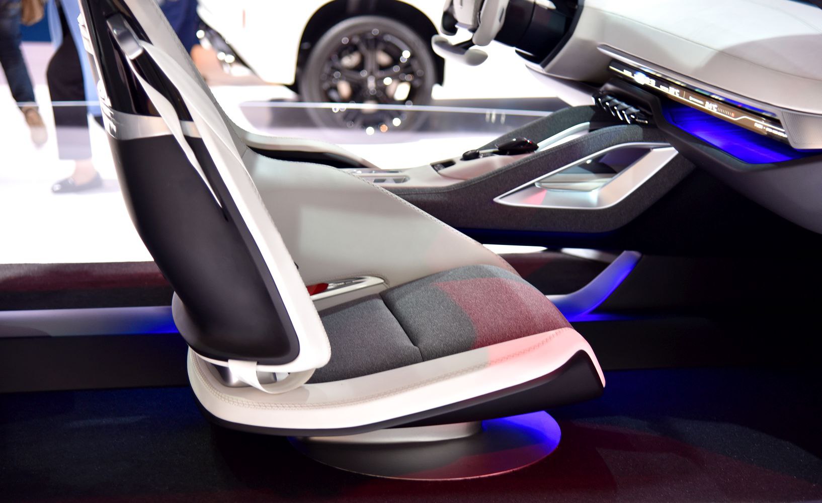 Futuristic car seat design with ambient blue lighting and modern console layout