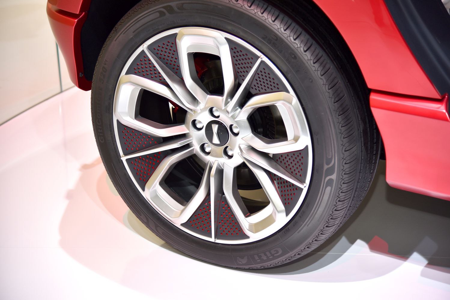 Close-up view of a multi-spoke alloy wheel with perforated design.