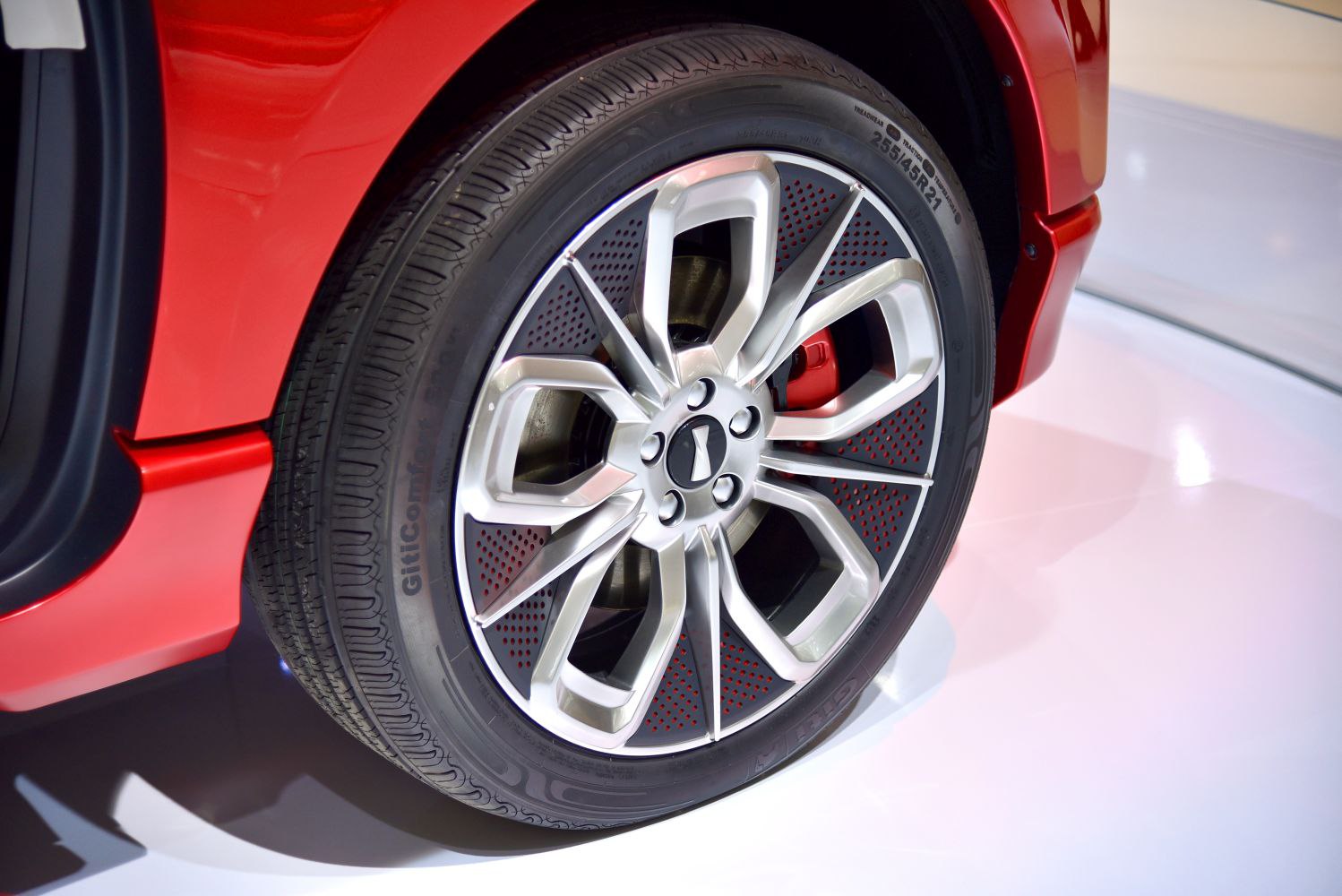 Close-up of a multi-spoke alloy wheel with a red brake caliper.