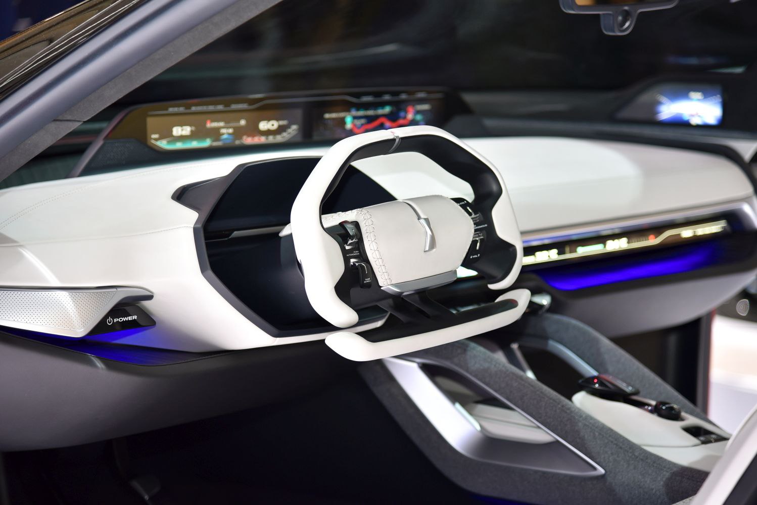 Futuristic steering wheel and digital dashboard in car interior