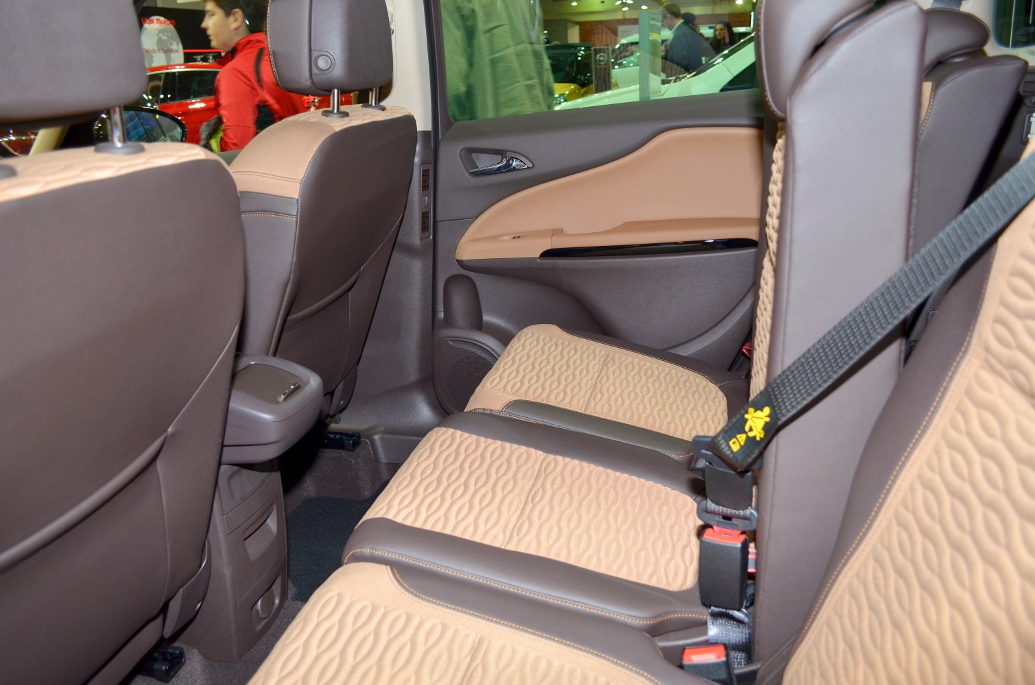 Rear seats with brown and beige upholstery and visible seatbelt