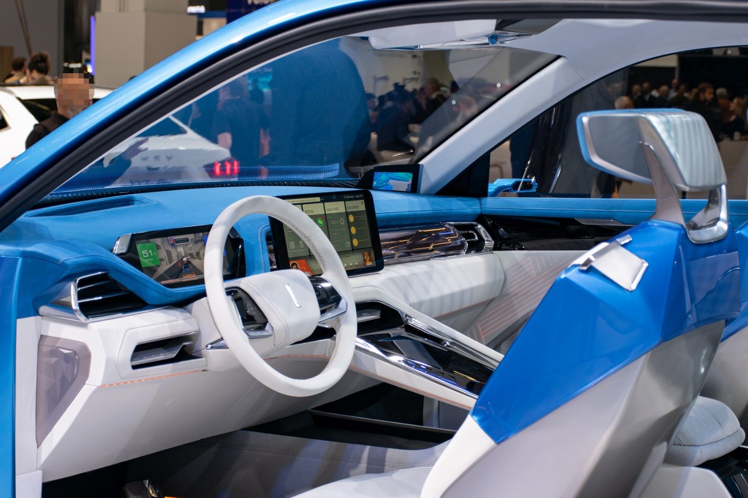 Futuristic dashboard with digital displays and innovative steering wheel design.