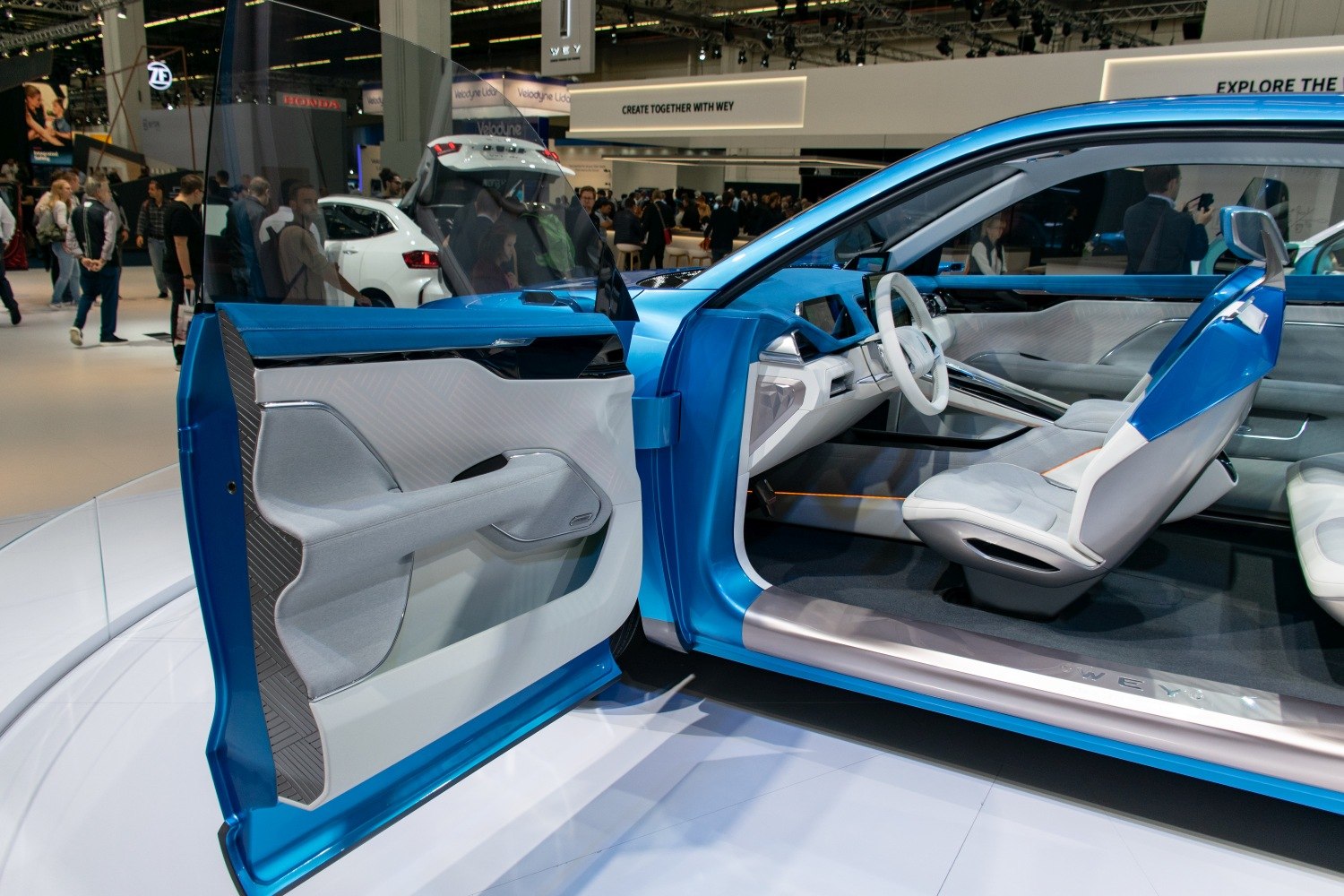 Futuristic car interior with open driver-side door and modern materials
