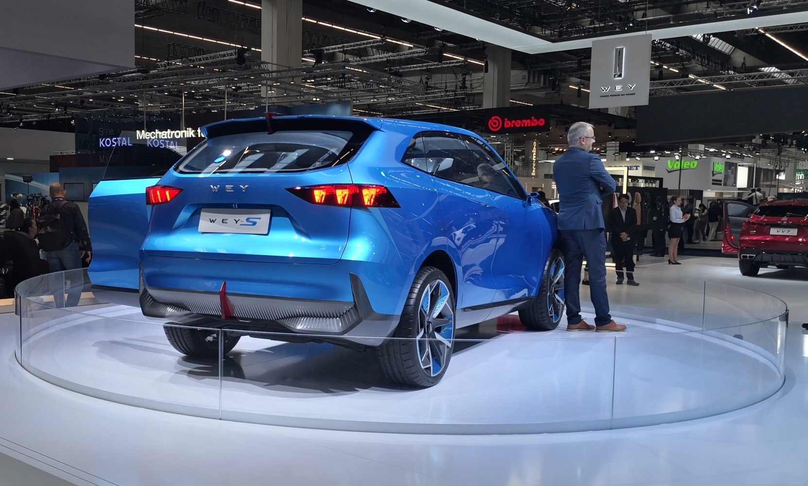 Sleek blue rear and side design with futuristic tail lights and large sporty wheels
