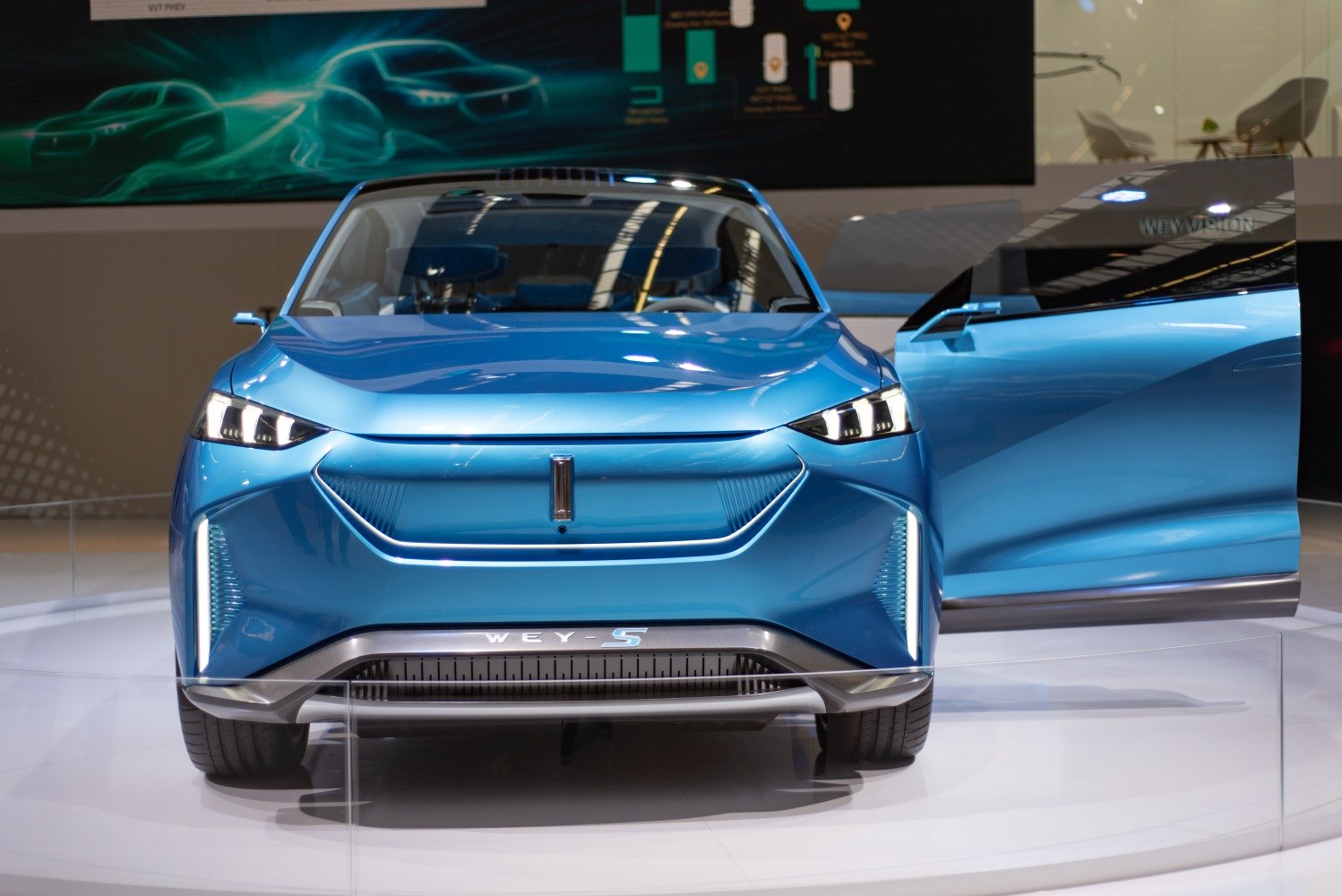 Front view of a blue SUV with LED headlights and open door
