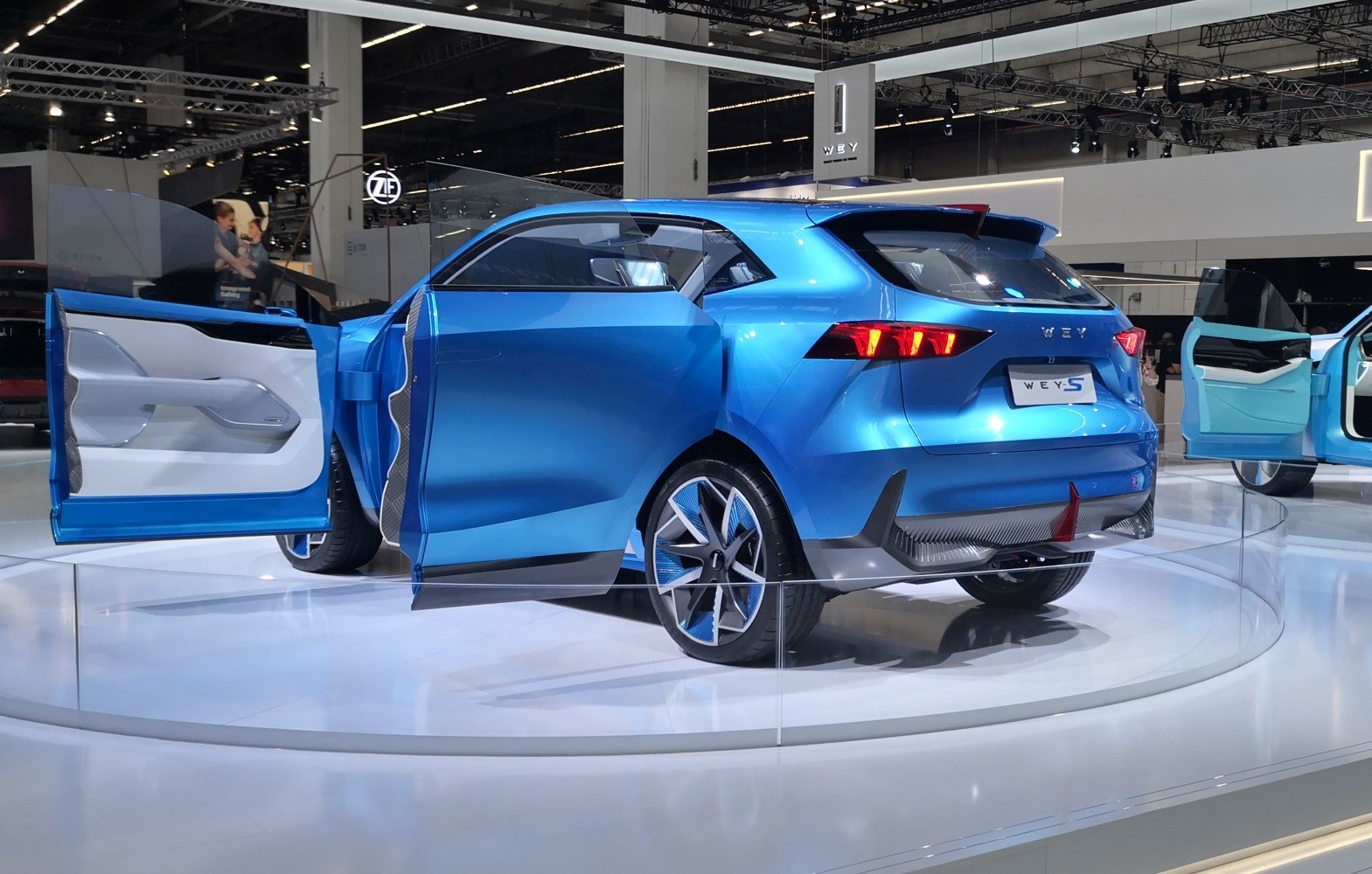 Sleek blue SUV with unique rear design and open distinctive doors