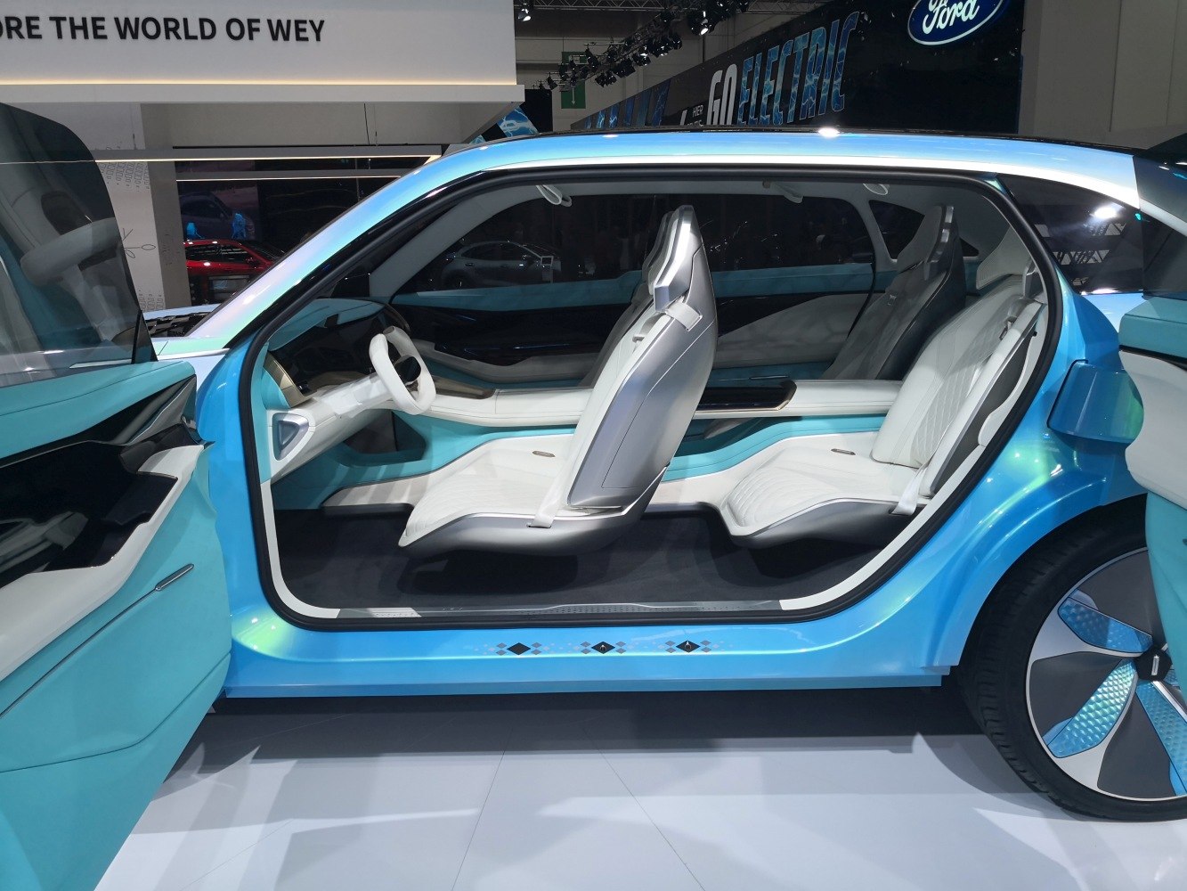 Futuristic white seating and open car door with blue interior accents