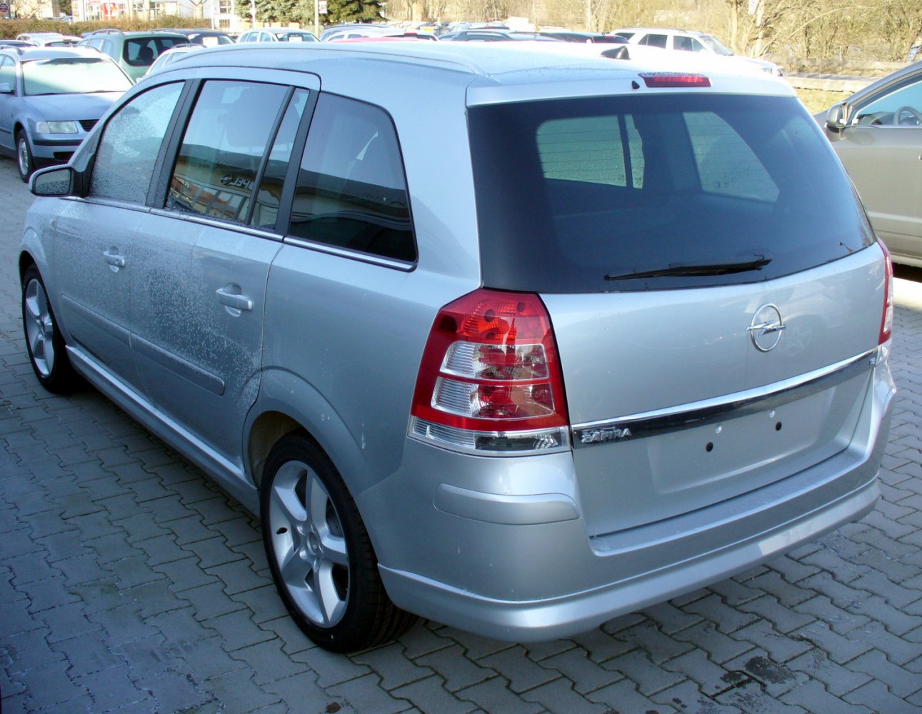 Silver minivan rear and side view with alloy wheels and tinted windows