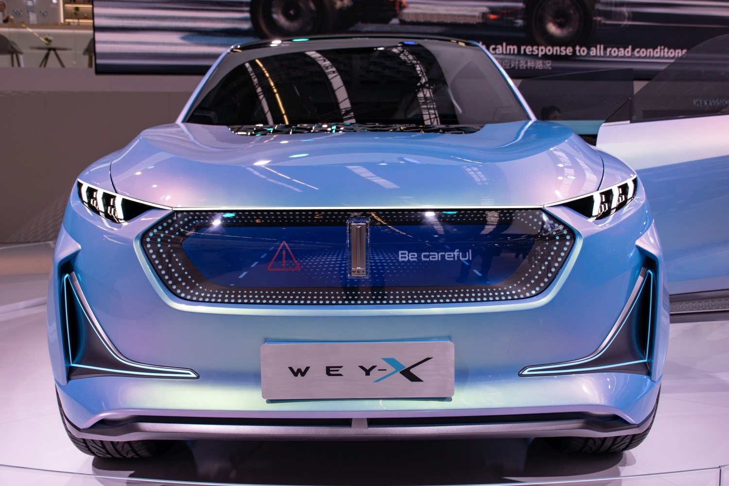 Futuristic front design with LED headlights and illuminated grille.