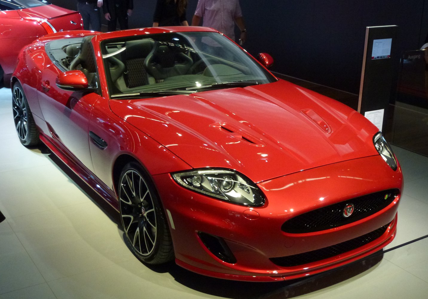 Red convertible with aggressive headlights and stylish alloy wheels