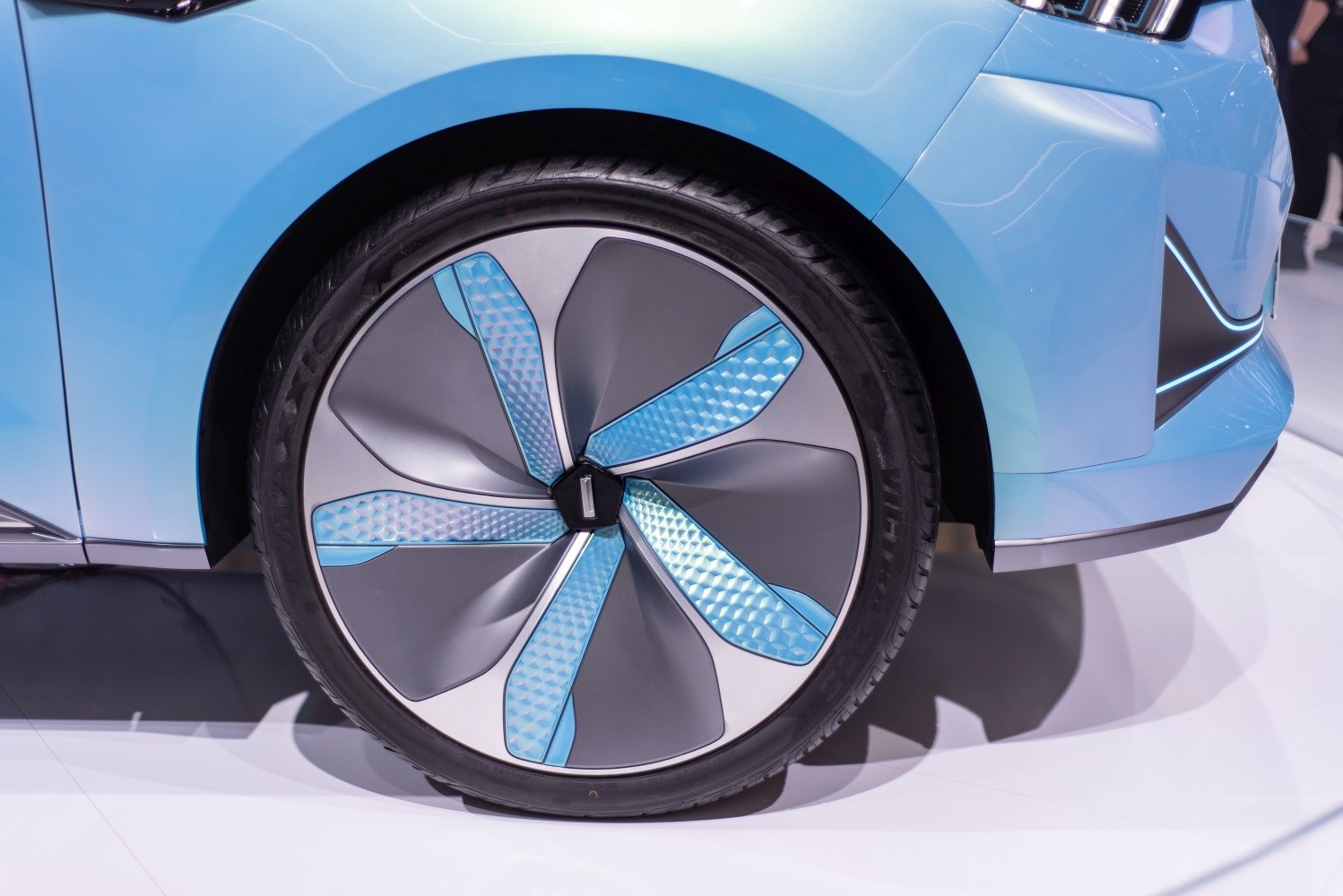 Futuristic alloy wheel with textured blue and grey sections