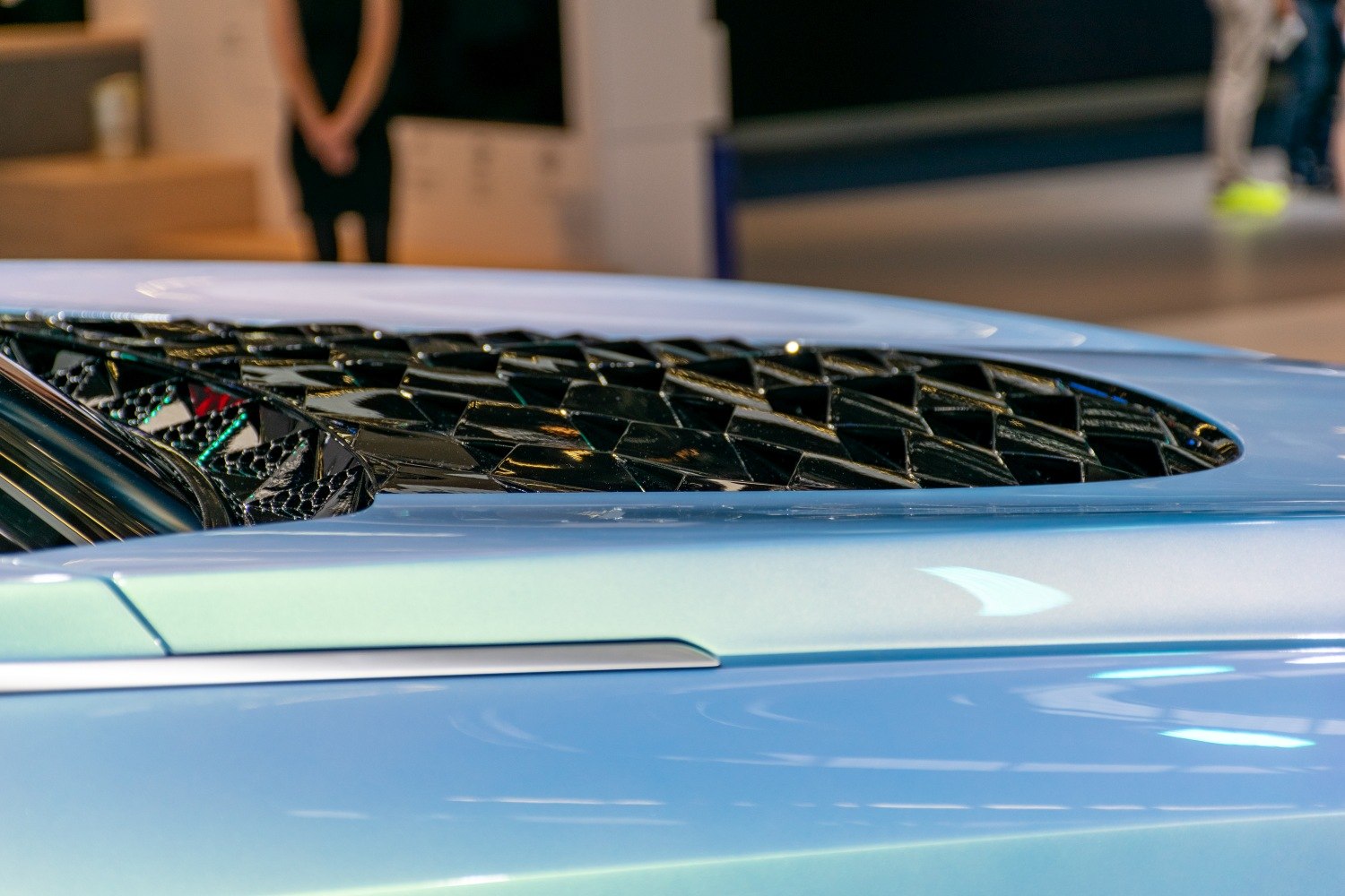 Black lattice vent detail on blue car body side