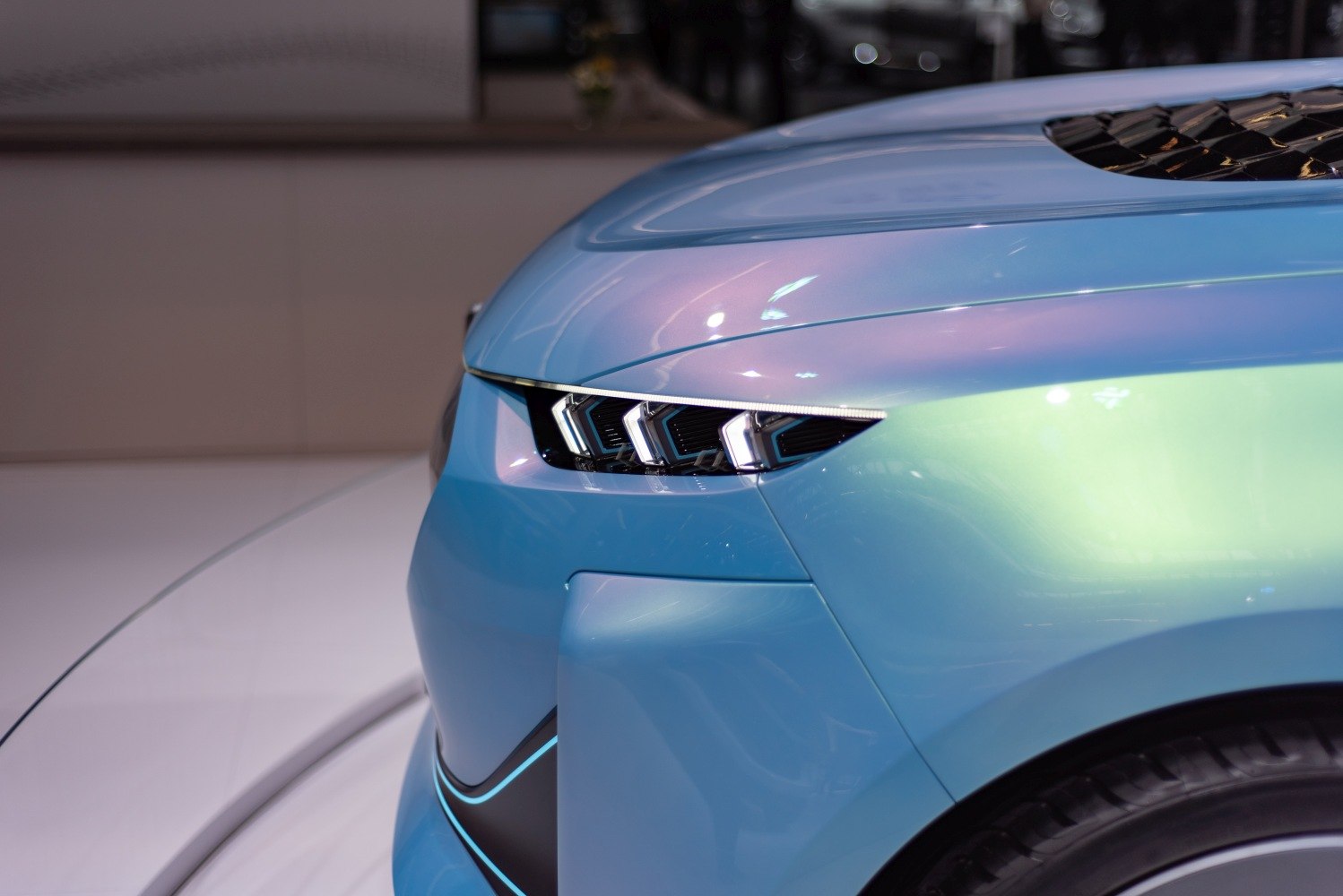 Close-up of futuristic LED headlights and front fender design