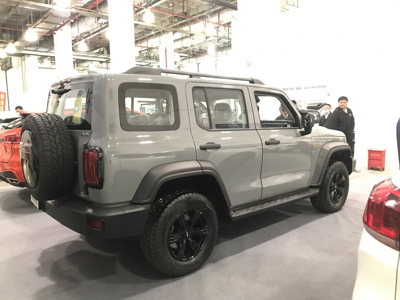 Grey off-road SUV with black wheels and rear spare tire