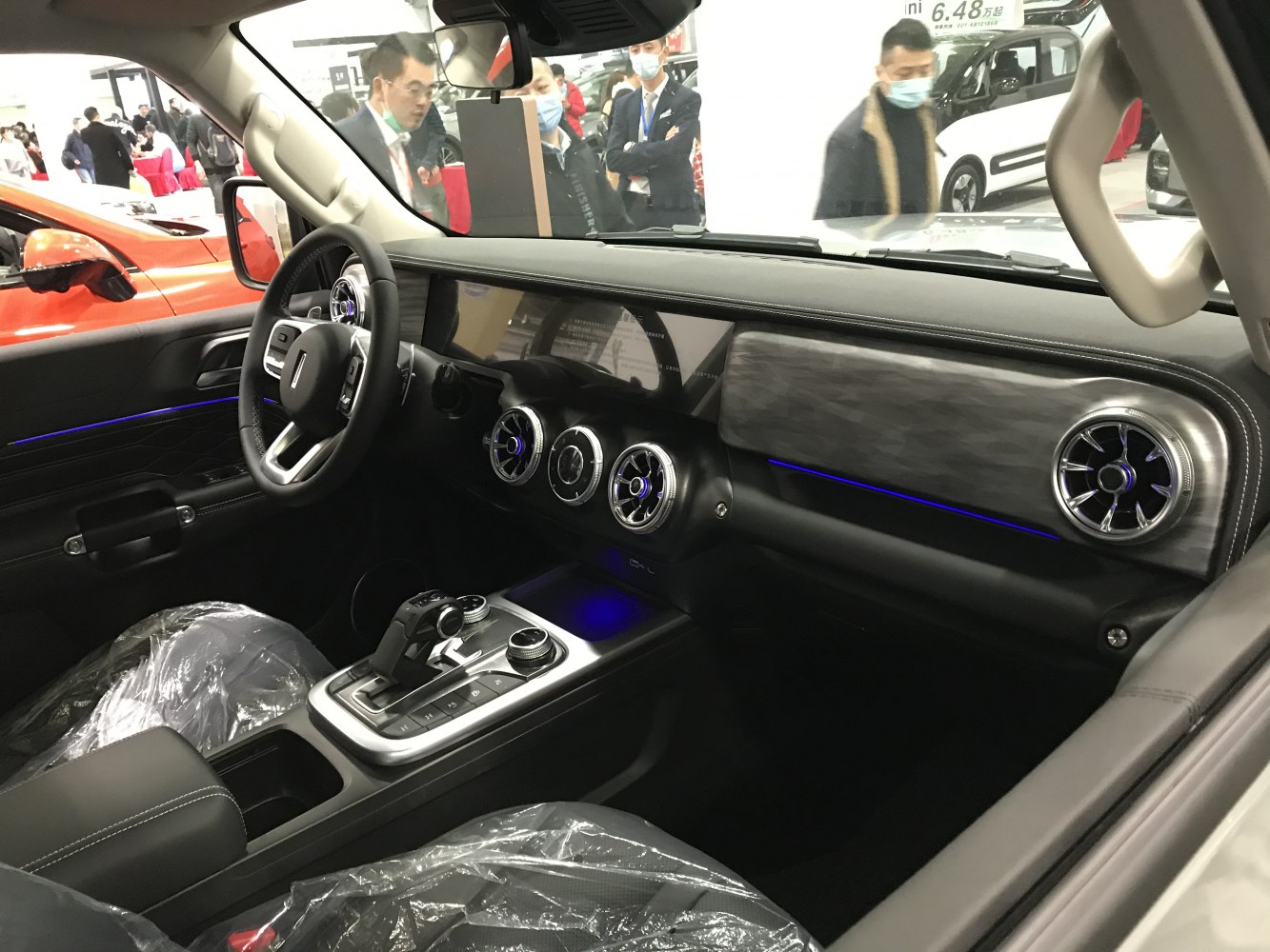 Modern SUV interior with circular air vents and center console controls