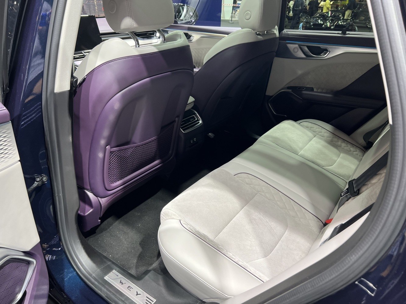 Rear passenger seat and interior design with leather upholstery and rear air vents.